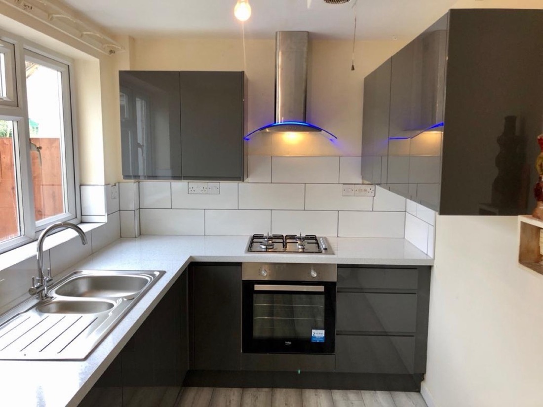 Grey gloss fitted kitchen with new sink, tap and oven