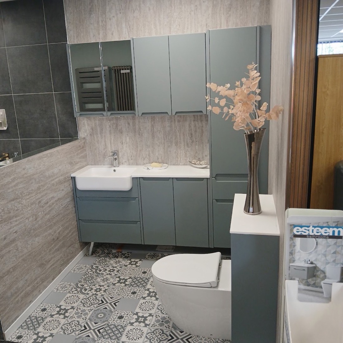 Bathroom with green cabinetry, wall-hung basin and patterned floor